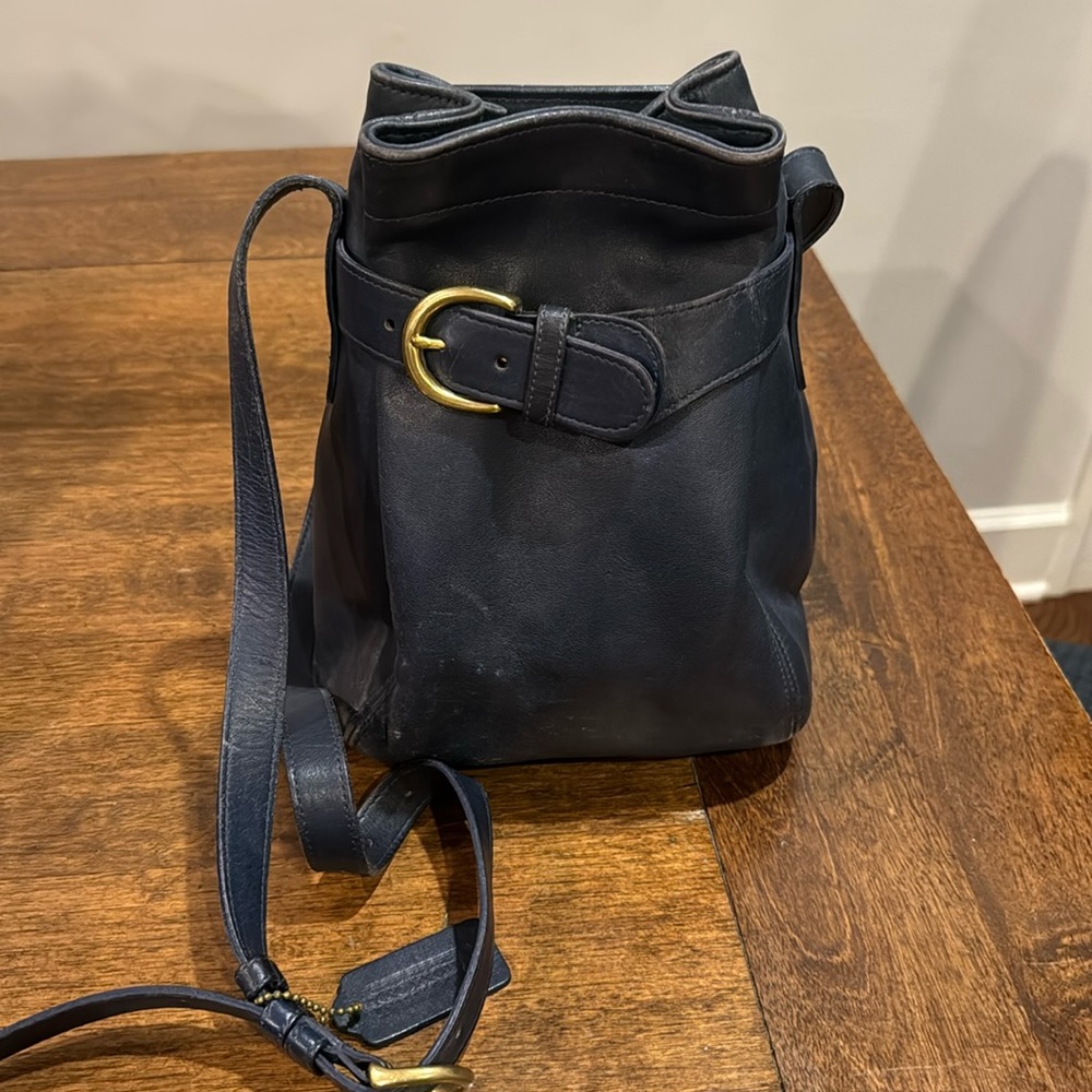 Blue leather coach shoulder bag or crossbody with gold buckle and adjust strap.
